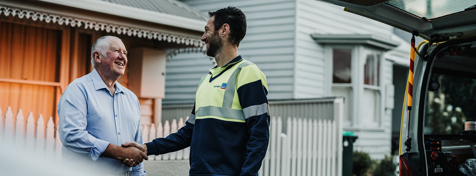 Roadside patrolman and man shaking hands on the side of the road