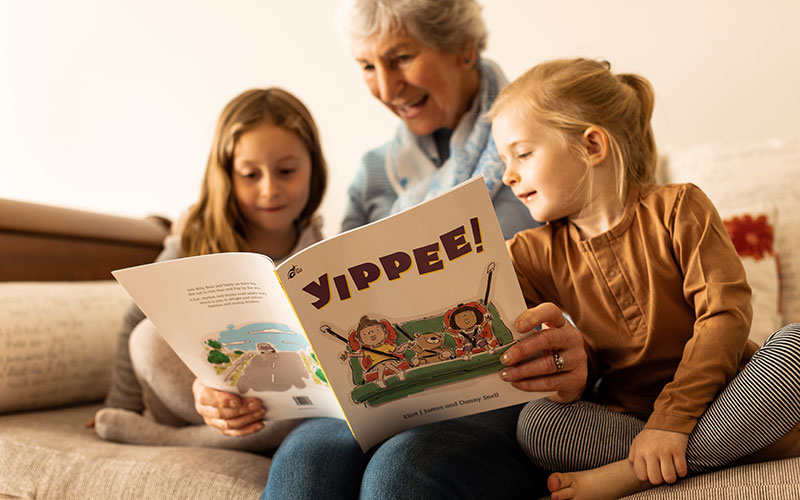 Grandmother reading Yippee to grand children