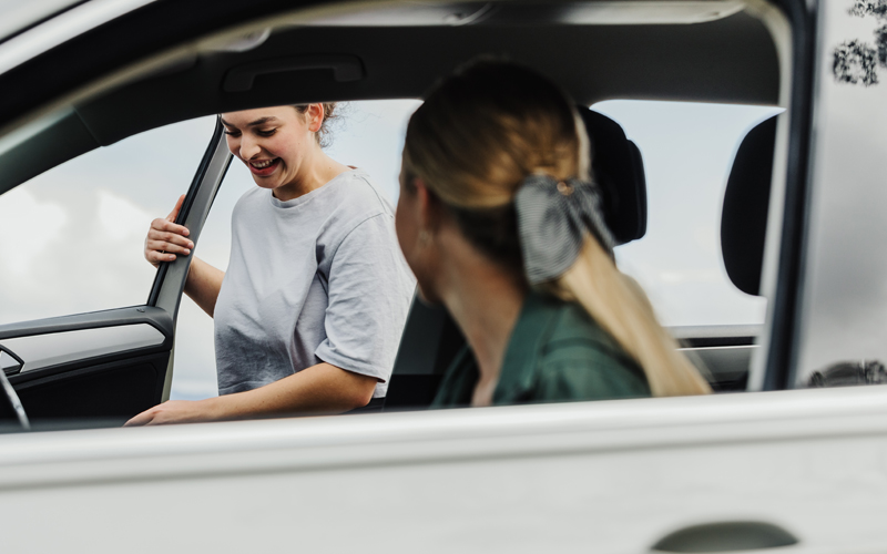 girl getting into car