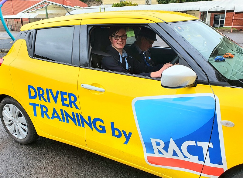 student in driver training car