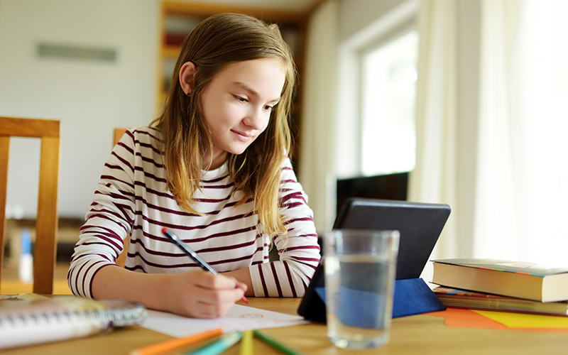 Young girl learning at home