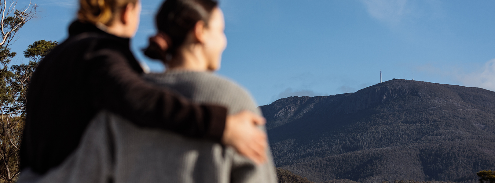 Two people looking up at Mount Wellington