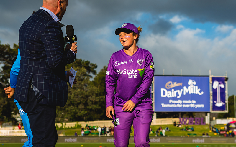 Corinne Hall speaking to media on cricket ground