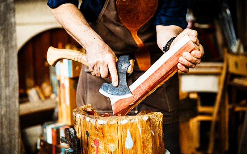 Carving wood into a spoon with a small axe