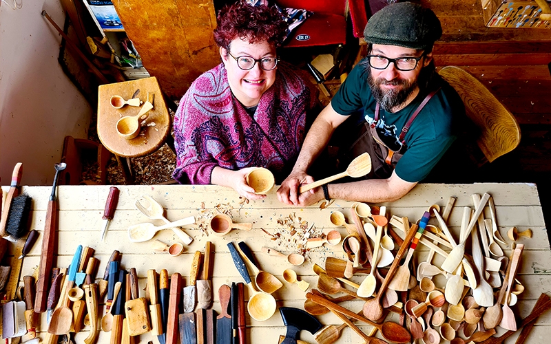Spoon makers with a table full of creations