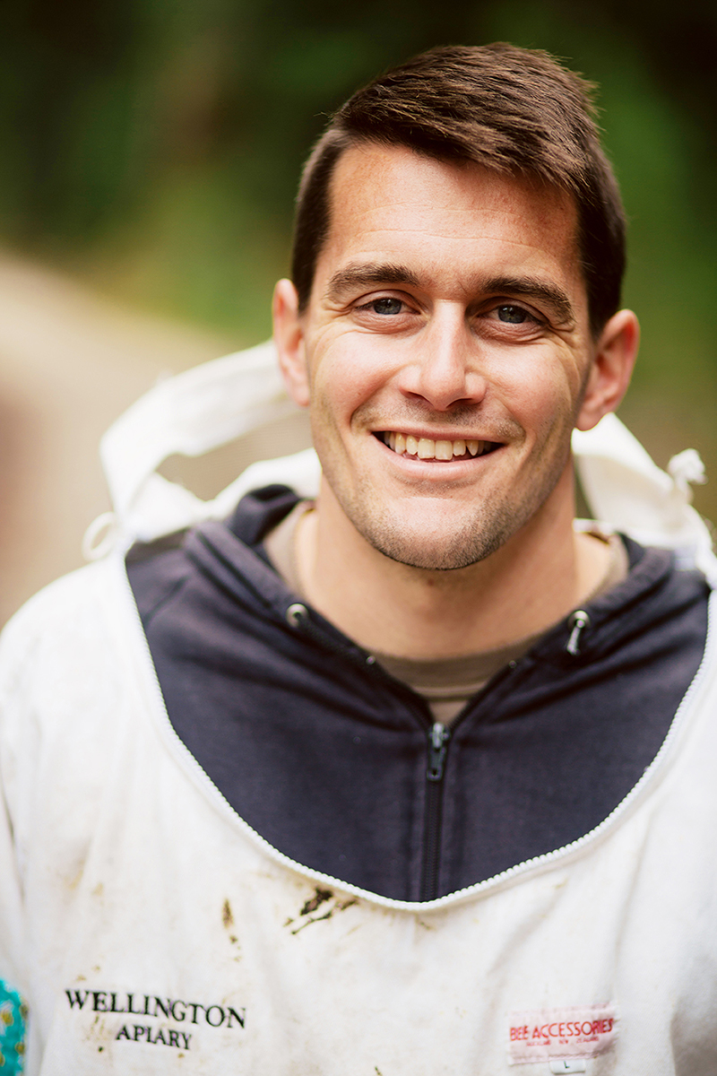 Robin O'Brien in his beekeeping suit smiling