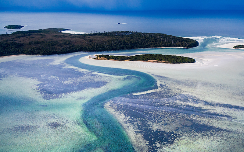Aerial view of Southport Lagoon with swirls of white sand and blue ocean