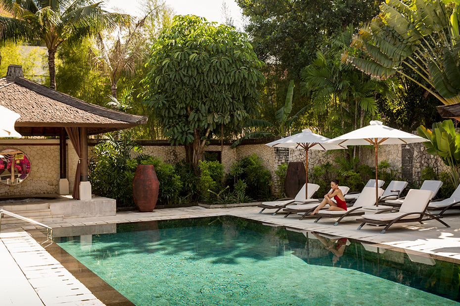 Woman relaxing by a bool in Bali