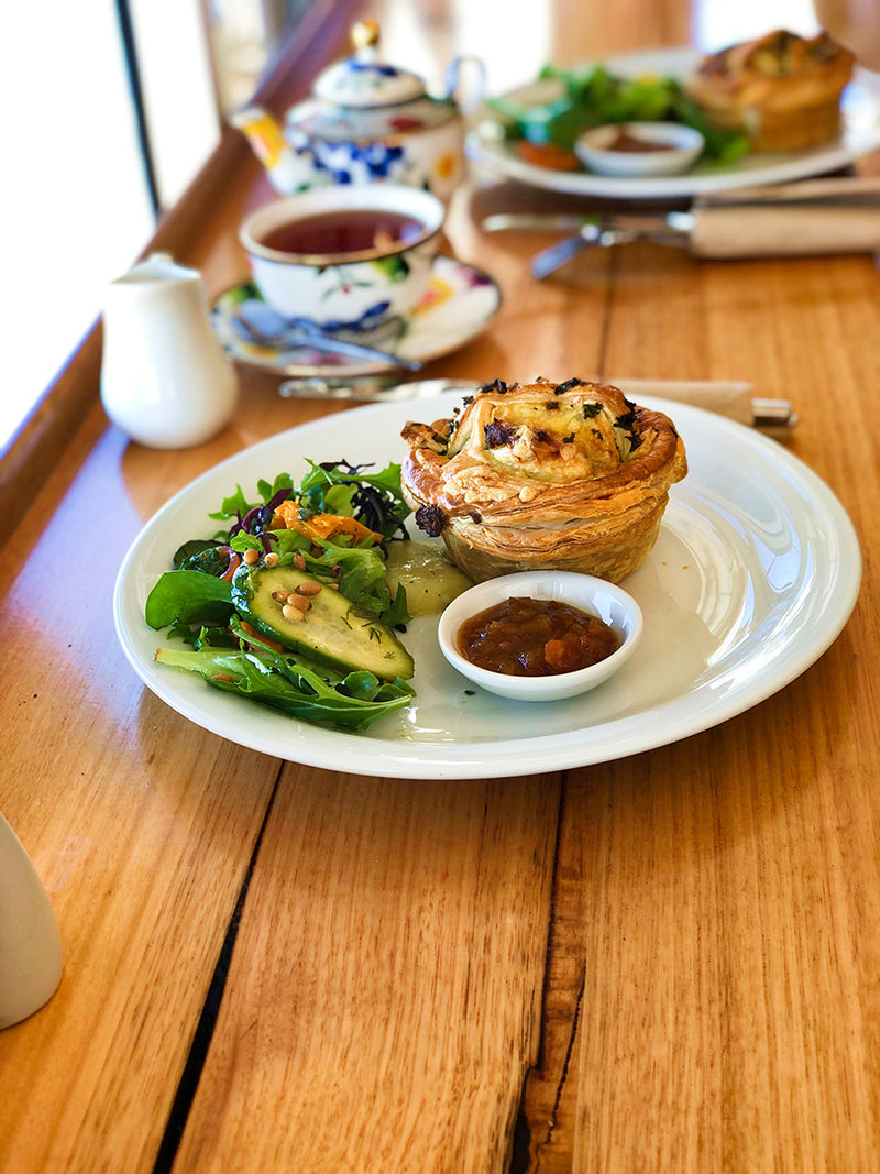 Pie and salad on a wooden table