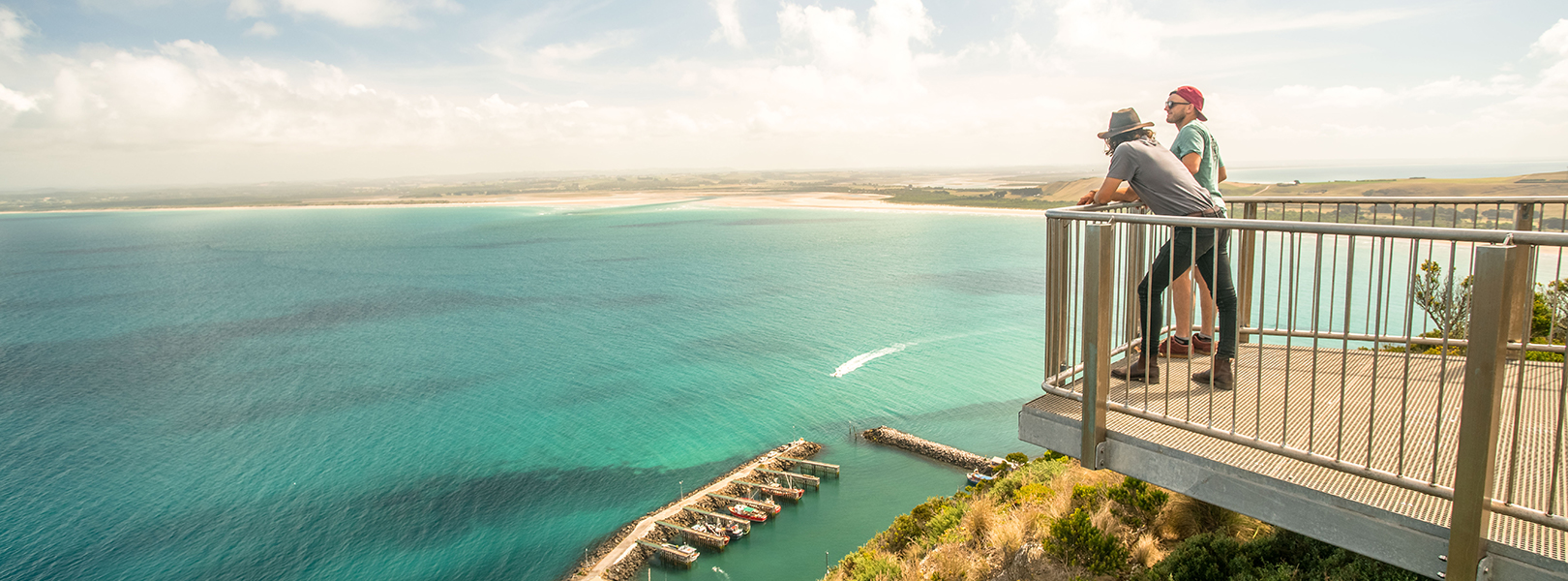 Two people standing at a lookout over the water at Stanley