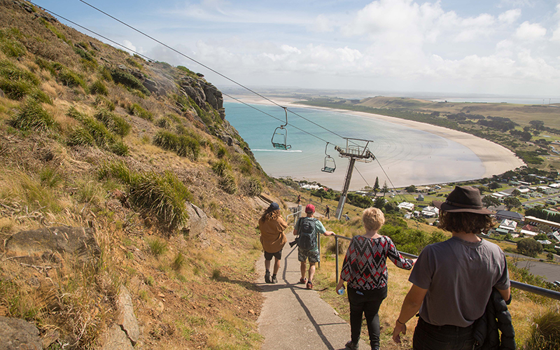 Tourists walking down the steep hill of The Nut