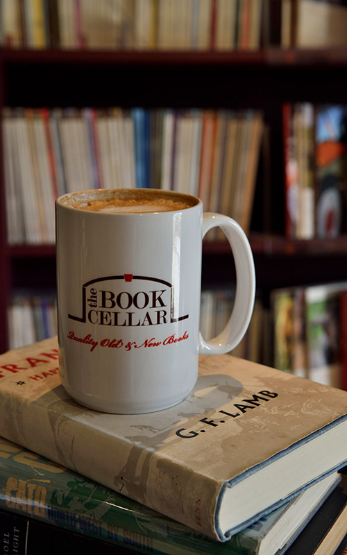 Coffee mug sitting on a book pile