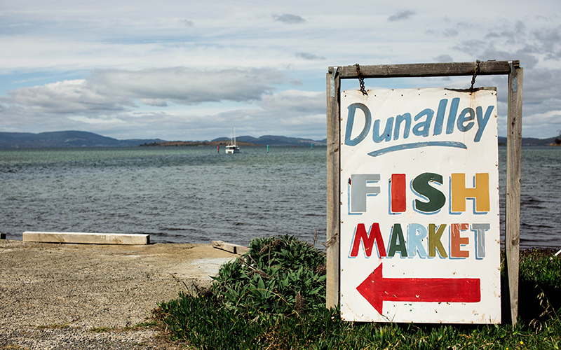 Dunalley Fish Market sign in front of water