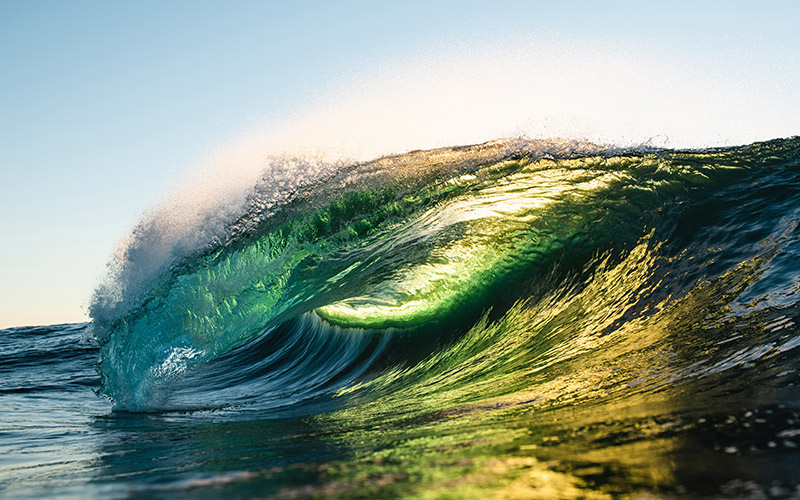 Waves crashing at Bicheno with the sun shining on the water