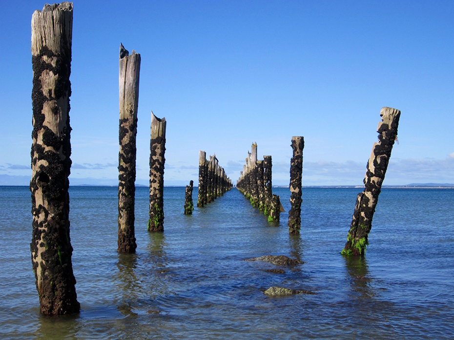 An old pier in the water at Bridport