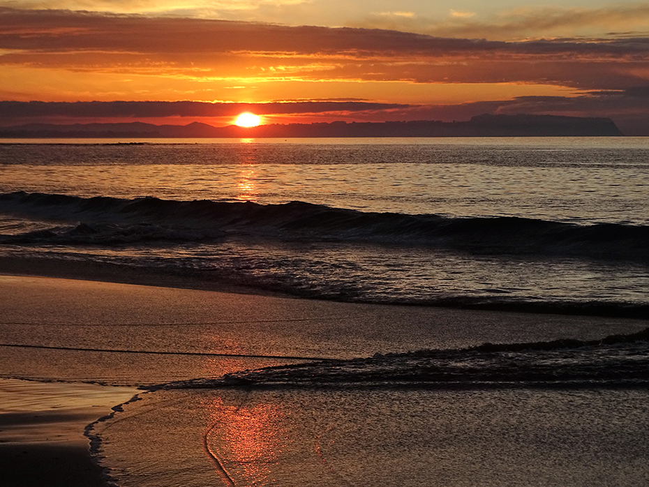 Orange sunset on the beach at Table Cape
