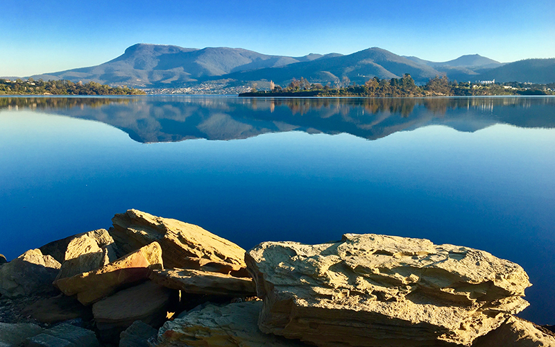 Reflections of Mount Wellington and blue skies