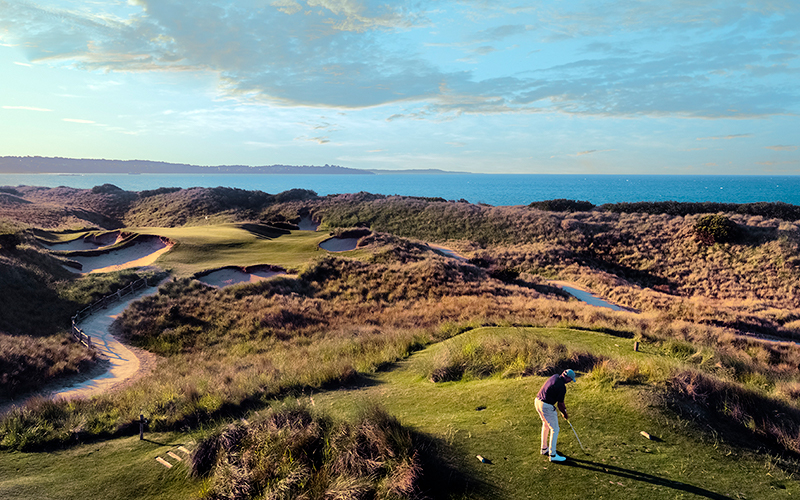 Person playing golf at the seaside