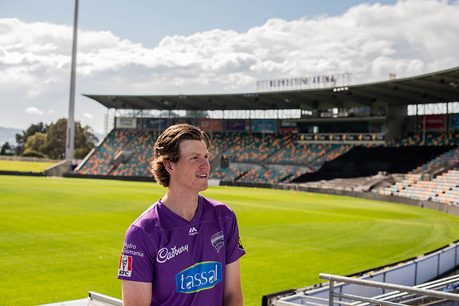 Mitch Owen standing in Blundstone Arena in purple Hobart Hurricanes uniform