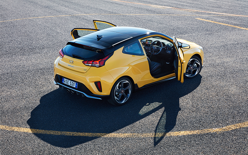Yellow Hyundai Veloster with three doors open