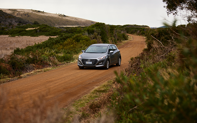 Silver car on dirt road