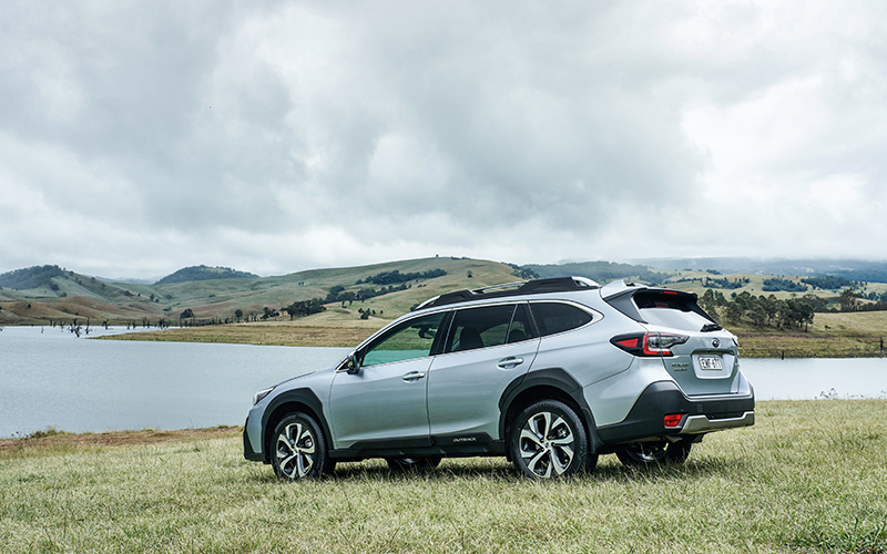 Silver Subaru Outback AWD Touring by a lake