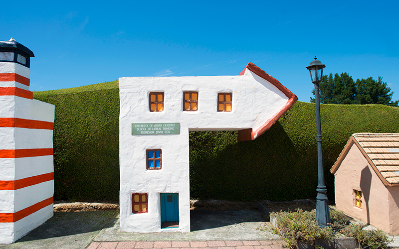 Entrance to Tasmazia with crooked house sign.