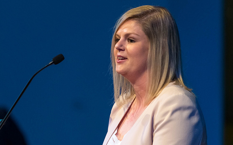 Amanda Sansom speaking into a microphone