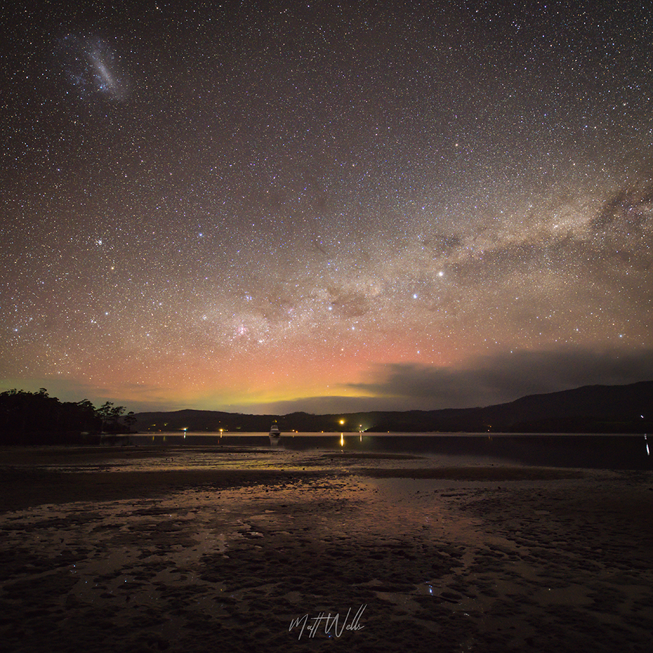 Pink and yellow aurora and stars