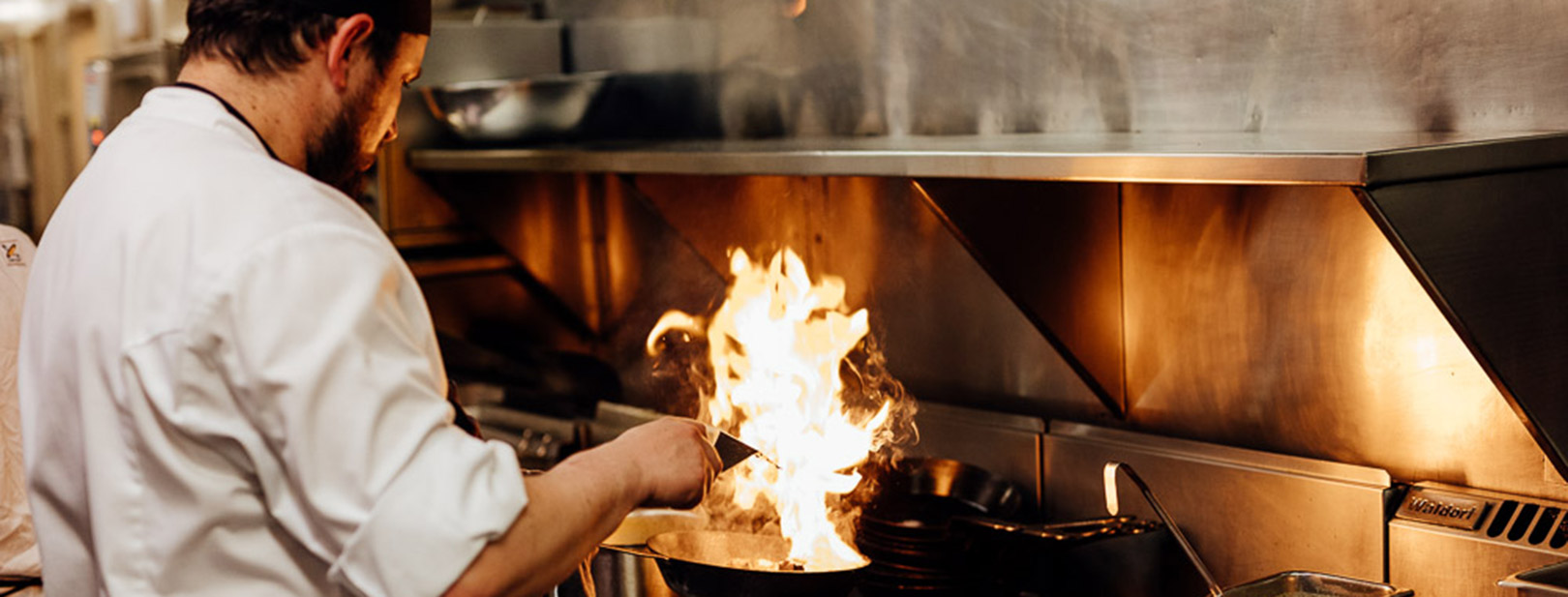 Chef firing up over grill