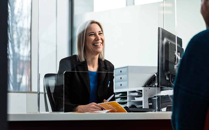 Consultant welcoming member at counter